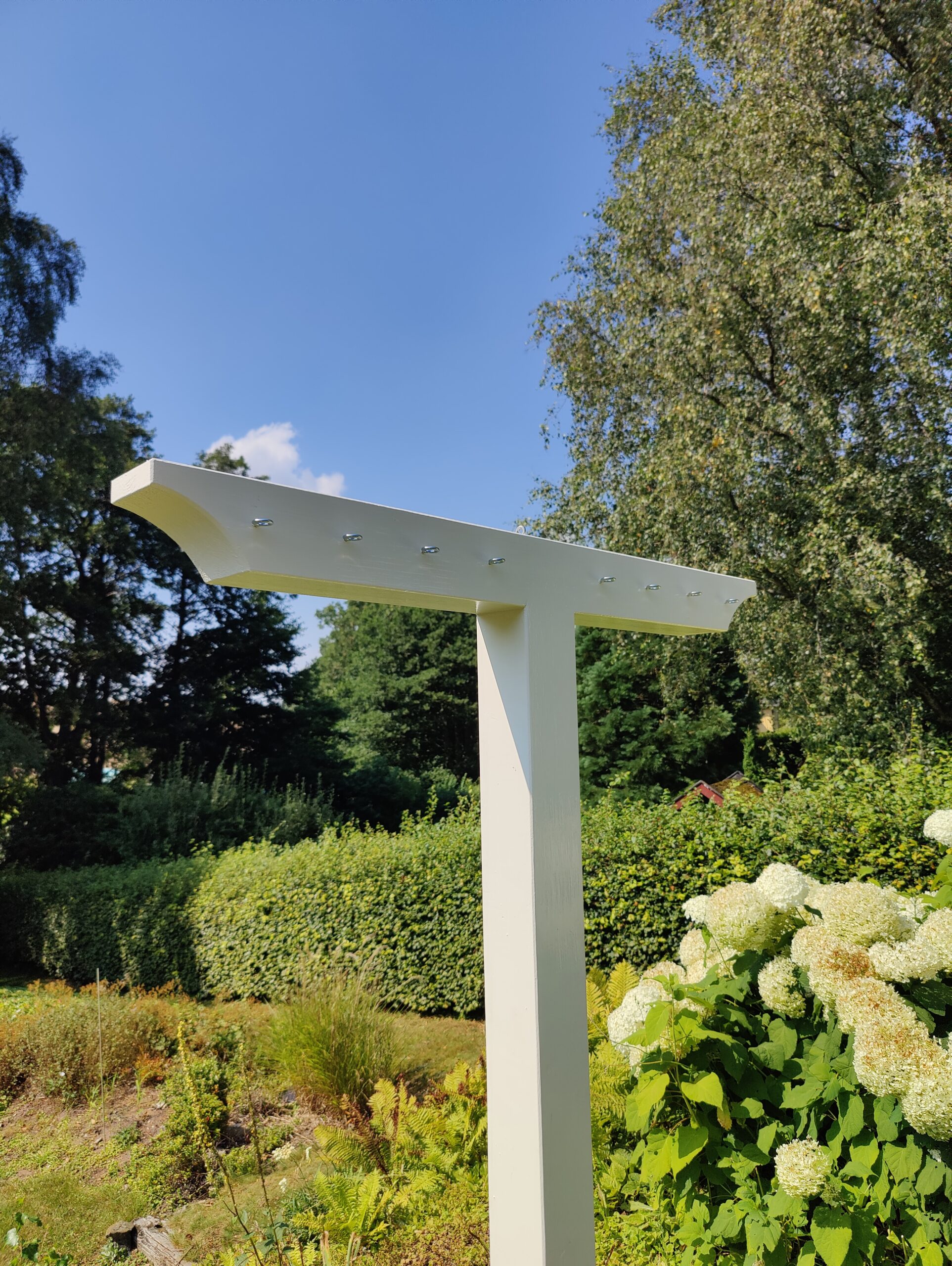 Torkställning i par, målad med krokar och rep.